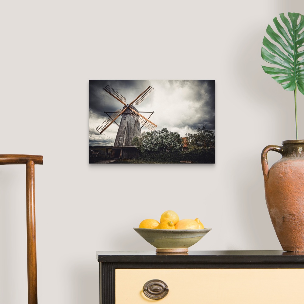 A traditional room featuring Old windmill in front of a stormy sky
