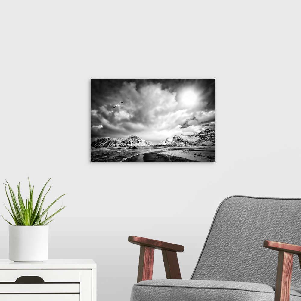 A modern room featuring A black and white photograph of a rugged mountainous landscape under a blanket of ornate and omin...