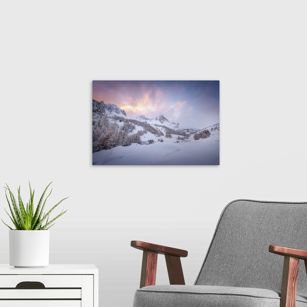 A modern room featuring Colored sunset landscape scene on a snowy mountain in the Alpes in France. A pine valley in winte...
