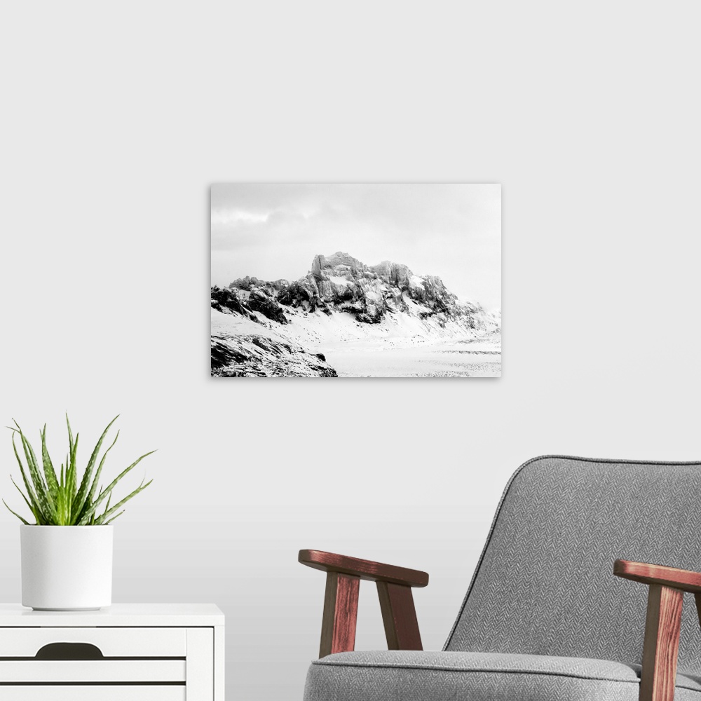 A modern room featuring A photograph of a rugged winter landscape.