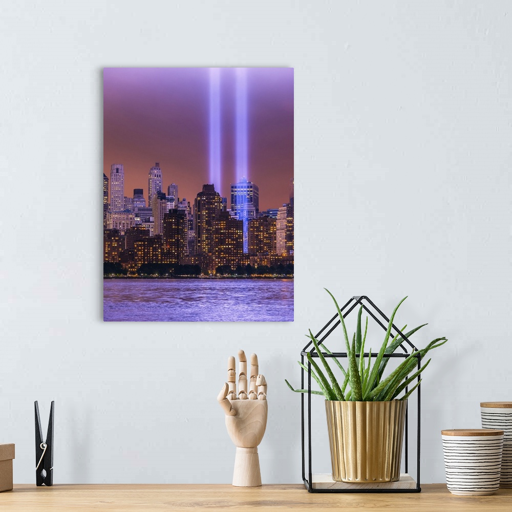 A bohemian room featuring Shafts of glowing bluish purple light surrounded by lower Manhattan lit buildings and reflected i...