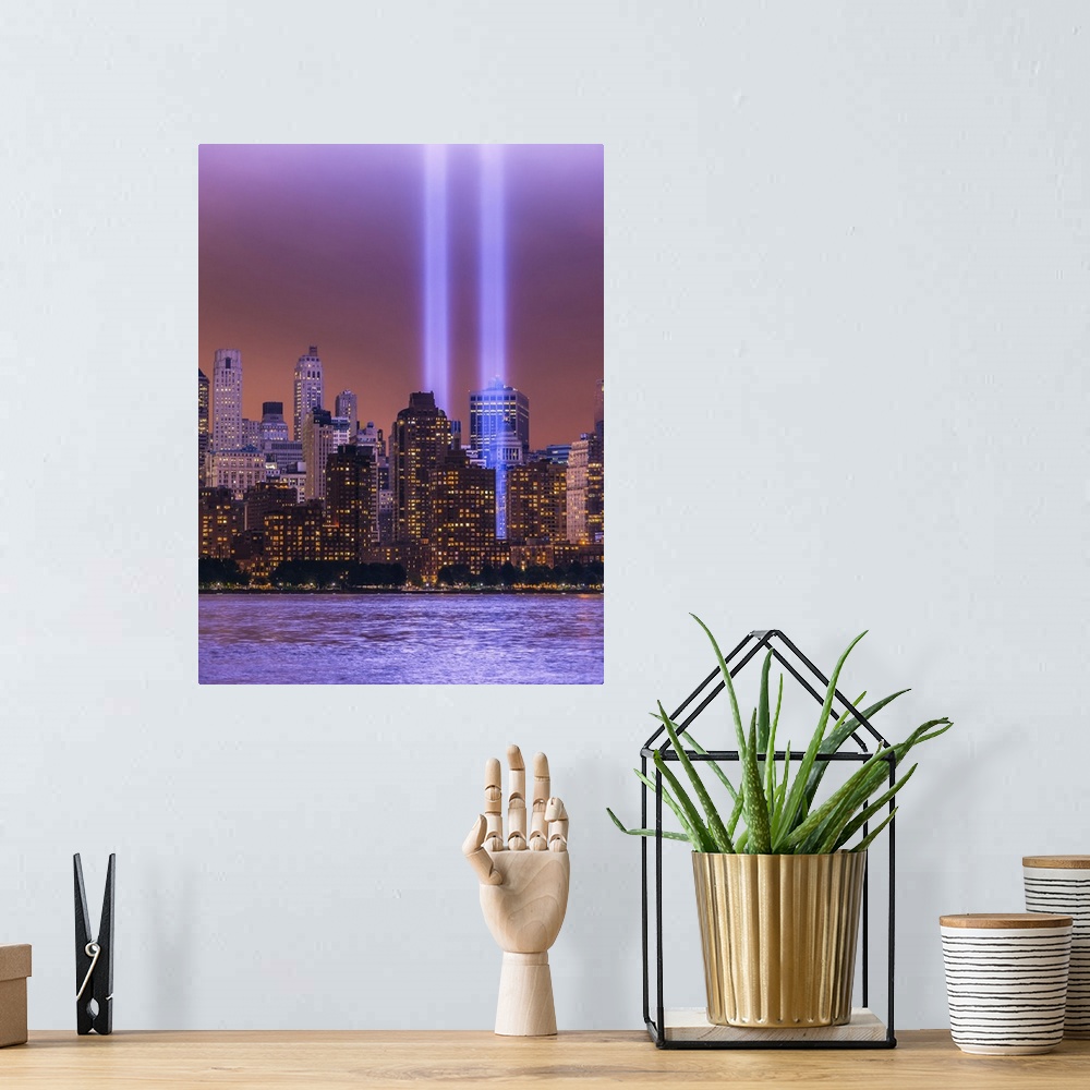 A bohemian room featuring Shafts of glowing bluish purple light surrounded by lower Manhattan lit buildings and reflected i...