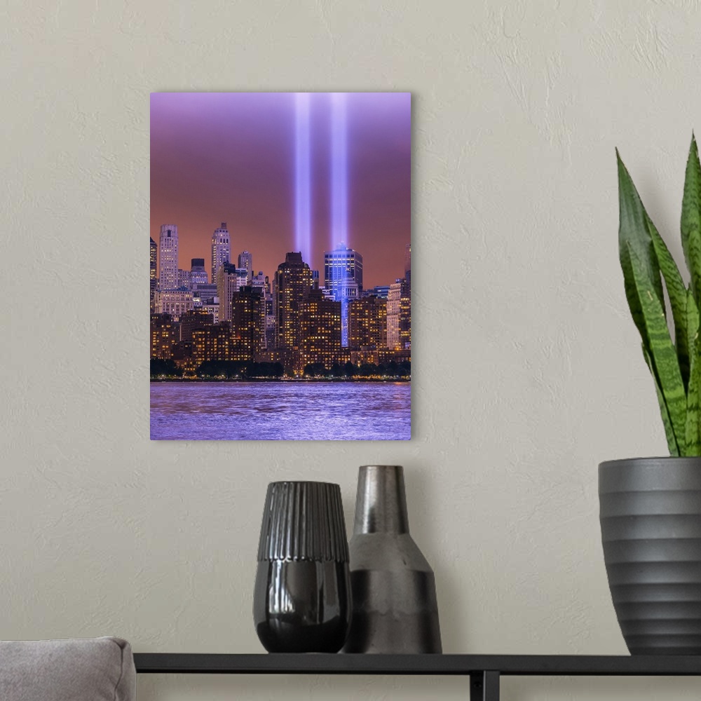 A modern room featuring Shafts of glowing bluish purple light surrounded by lower Manhattan lit buildings and reflected i...