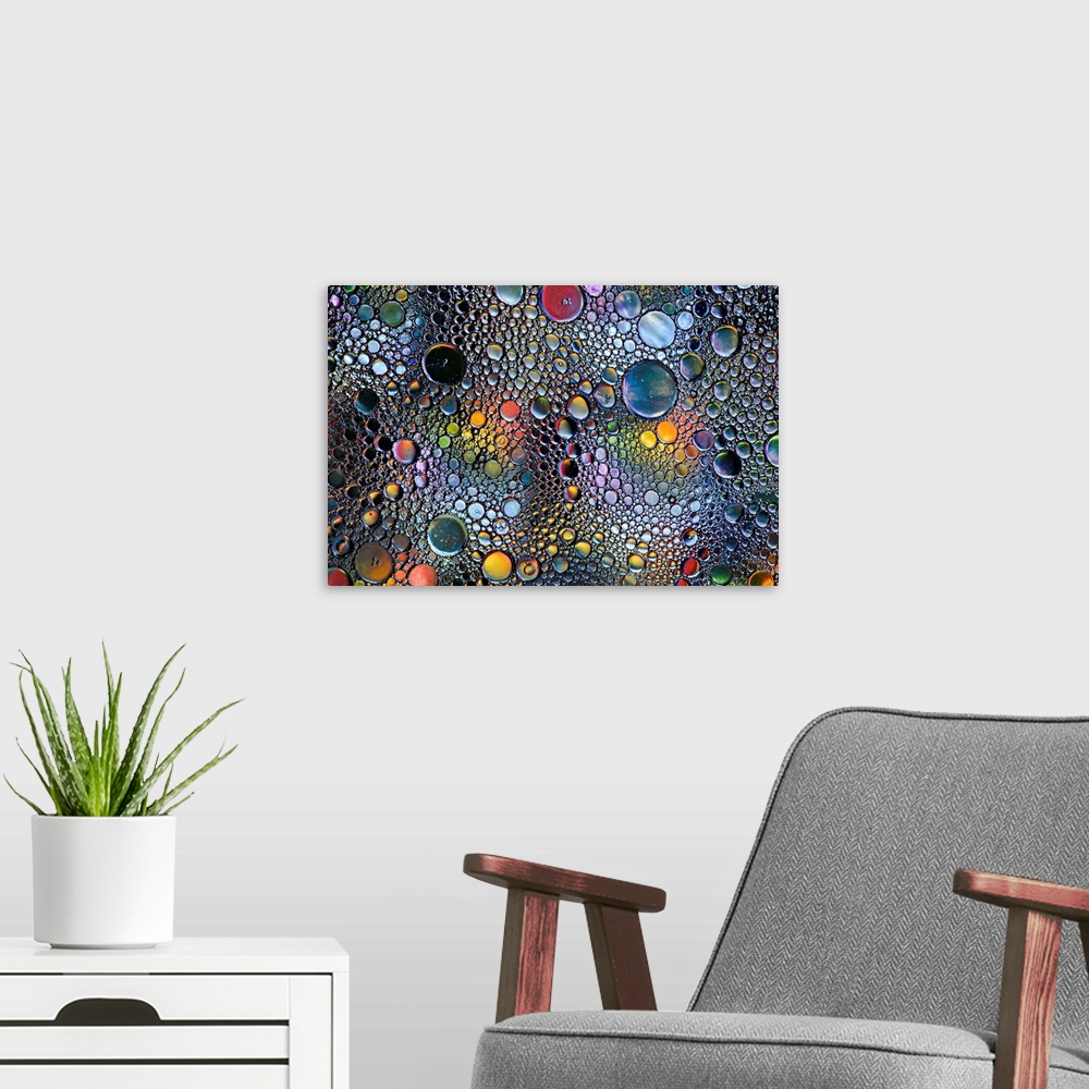 A modern room featuring Abstract photo of a multitude of bubbles in rainbow colors of different sizes.