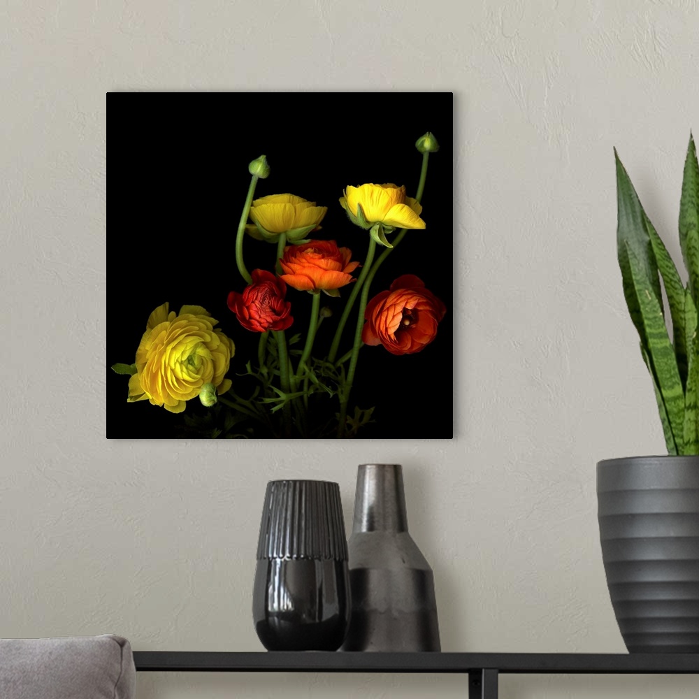 A modern room featuring Wall art of a colorful bouquet of beautiful yellow and red flowers and buds.