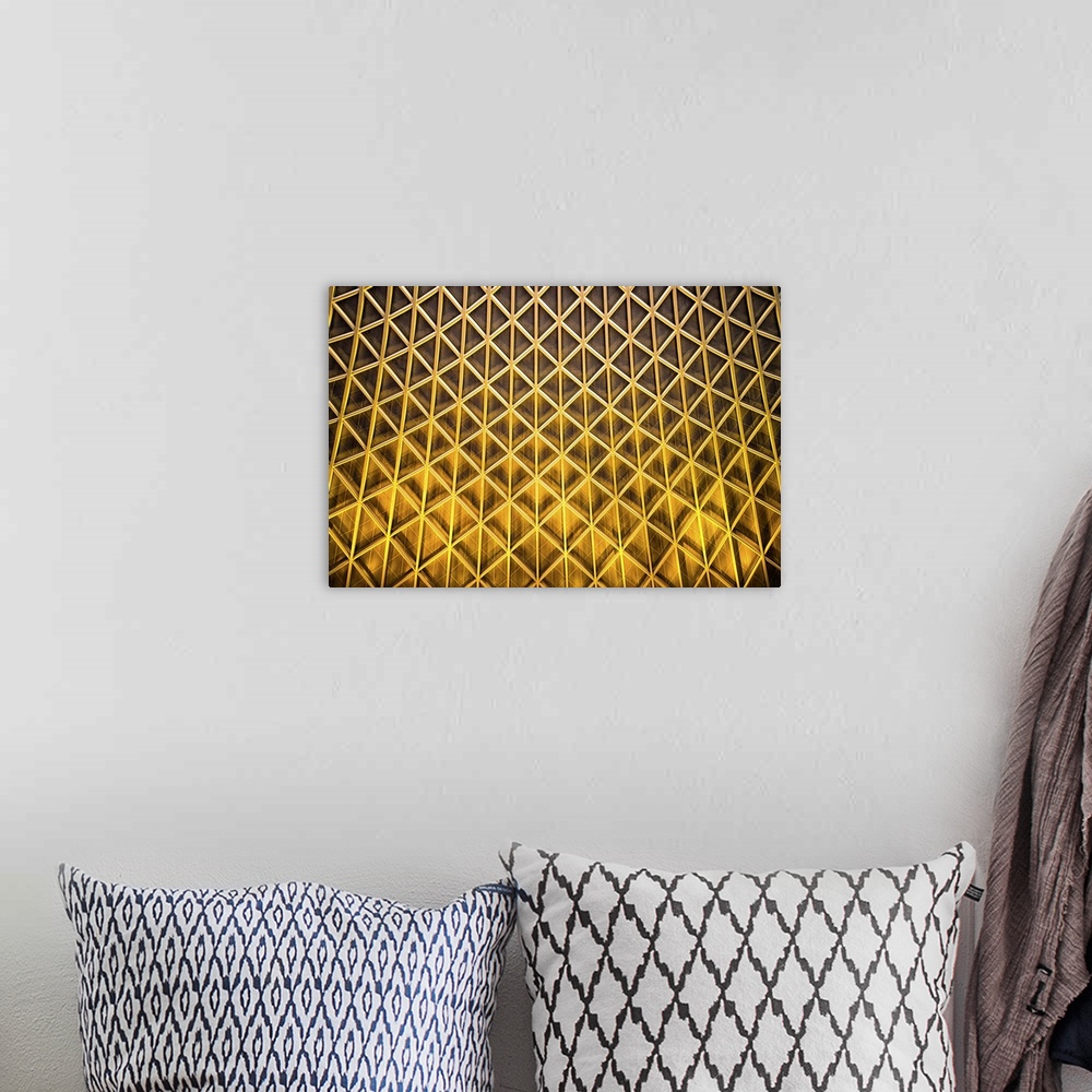A bohemian room featuring A photograph of an abstract view of gold patterned architectural details.