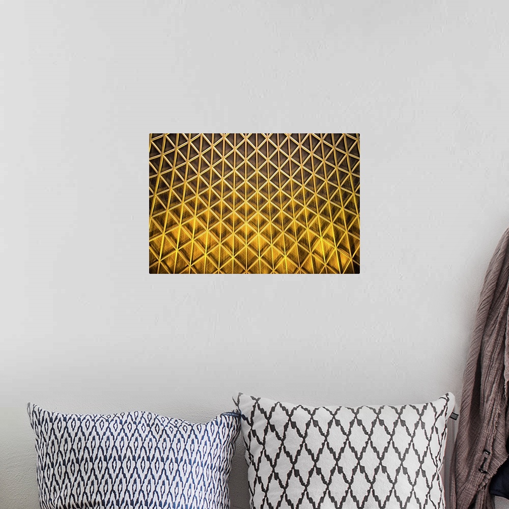A bohemian room featuring A photograph of an abstract view of gold patterned architectural details.