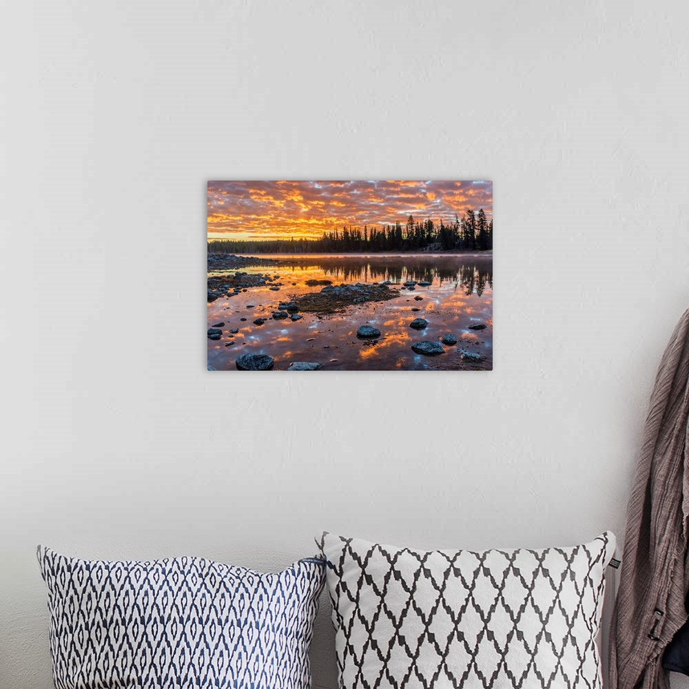 A bohemian room featuring Fine art photograph of a sunset illuminating the clouds over the Yellowstone River in Wyoming.