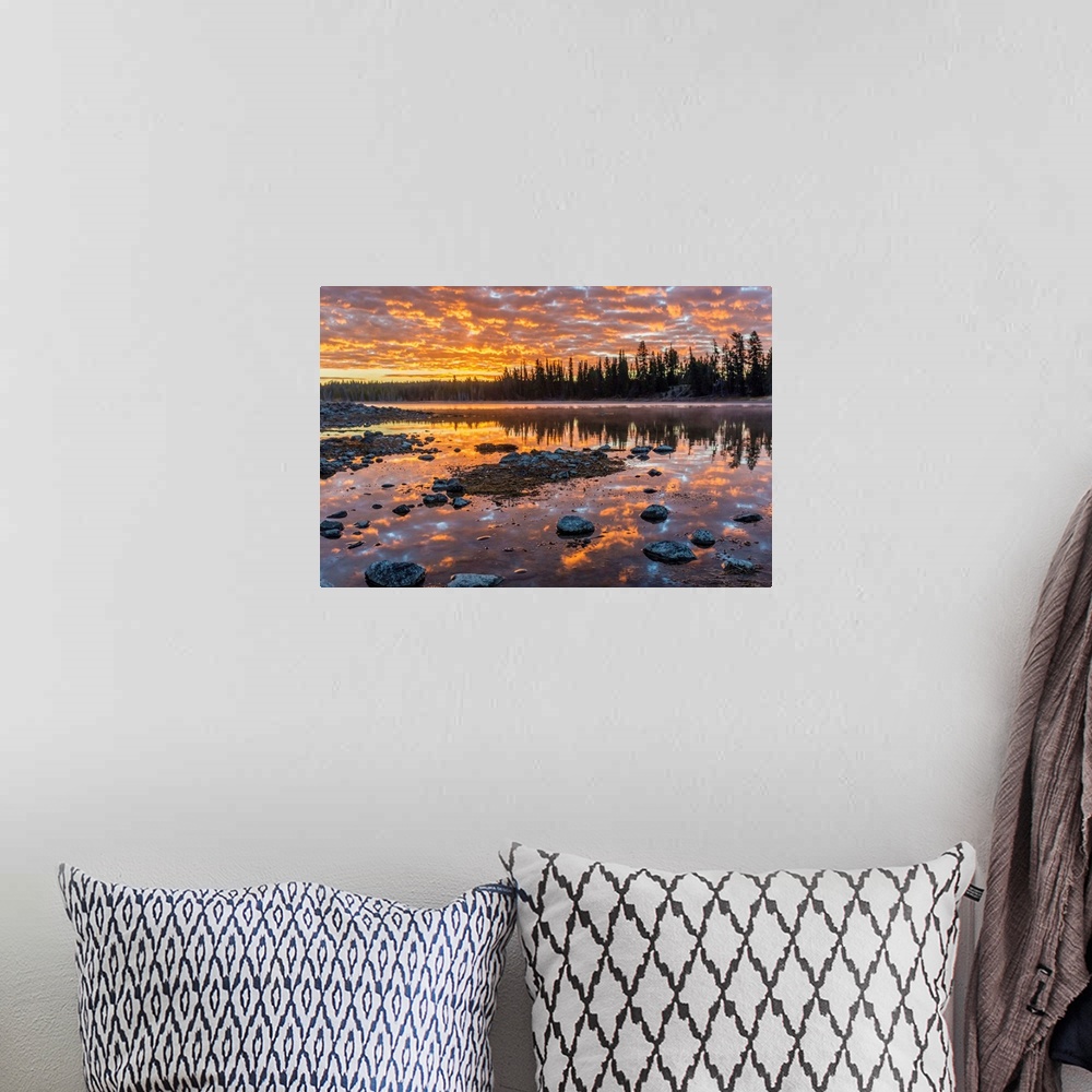 A bohemian room featuring Fine art photograph of a sunset illuminating the clouds over the Yellowstone River in Wyoming.