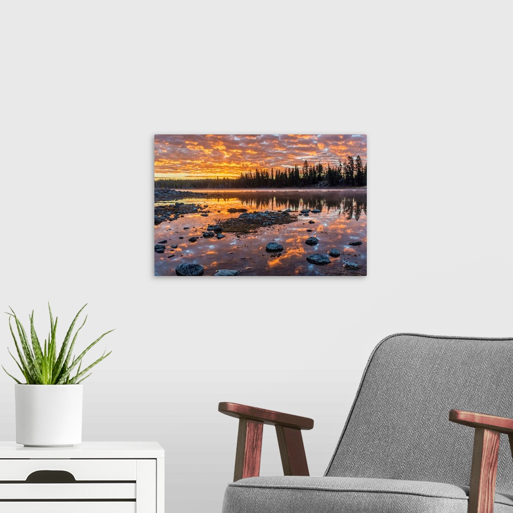 A modern room featuring Fine art photograph of a sunset illuminating the clouds over the Yellowstone River in Wyoming.
