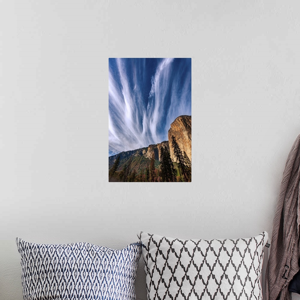 A bohemian room featuring This picture features clouds dramatically streaking the blue sky fanning out above Yosemite's El ...