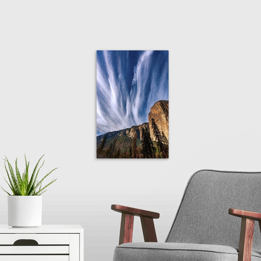 A modern room featuring This picture features clouds dramatically streaking the blue sky fanning out above Yosemite's El ...