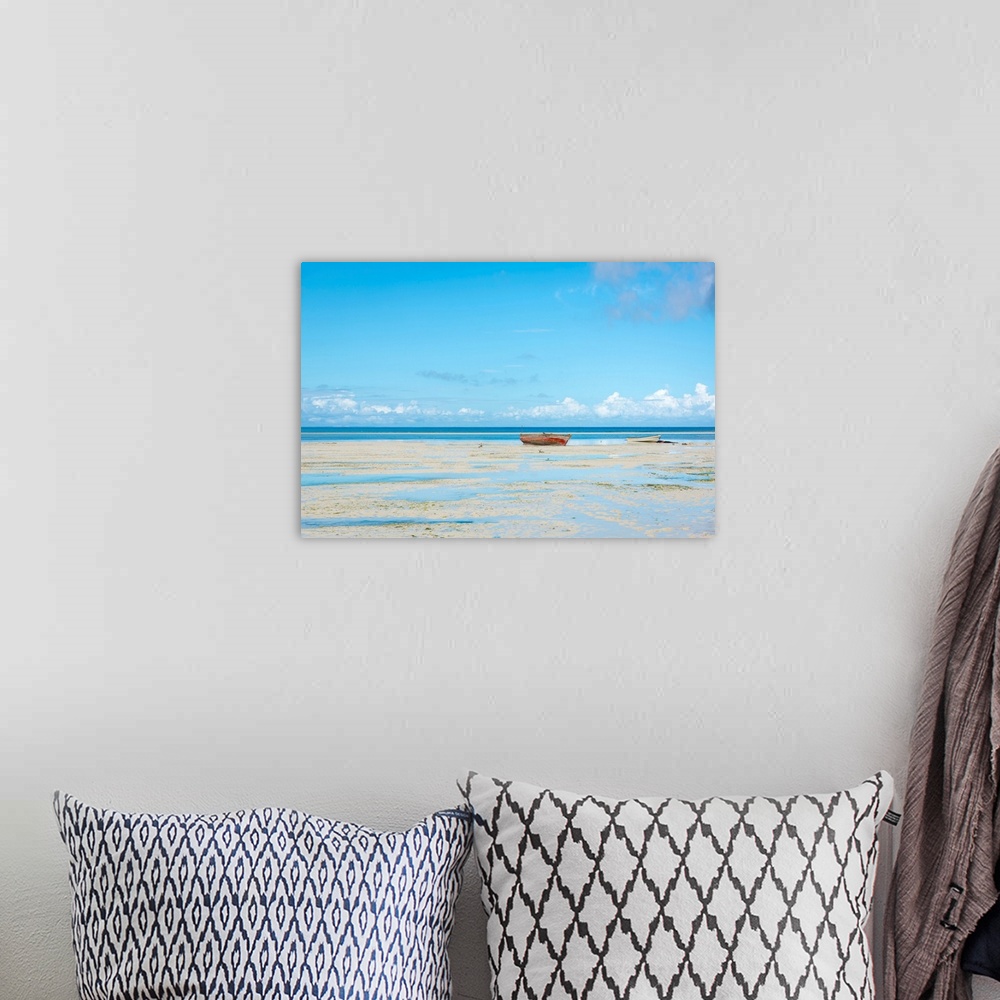A bohemian room featuring Photograph of a calm sea with a row boat along the shoreline.