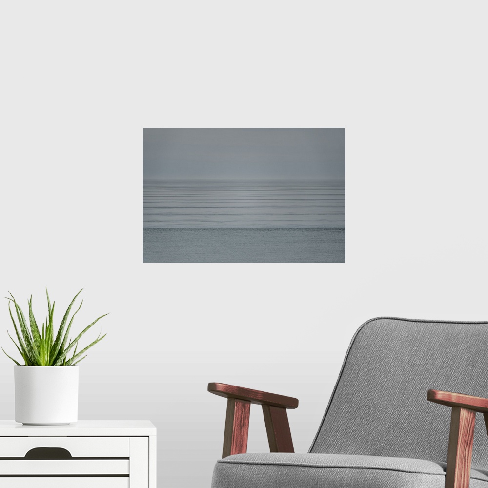 A modern room featuring Contemplate mindfulness and peace as you gaze upon this Zen scene of soft ocean ripples fading in...