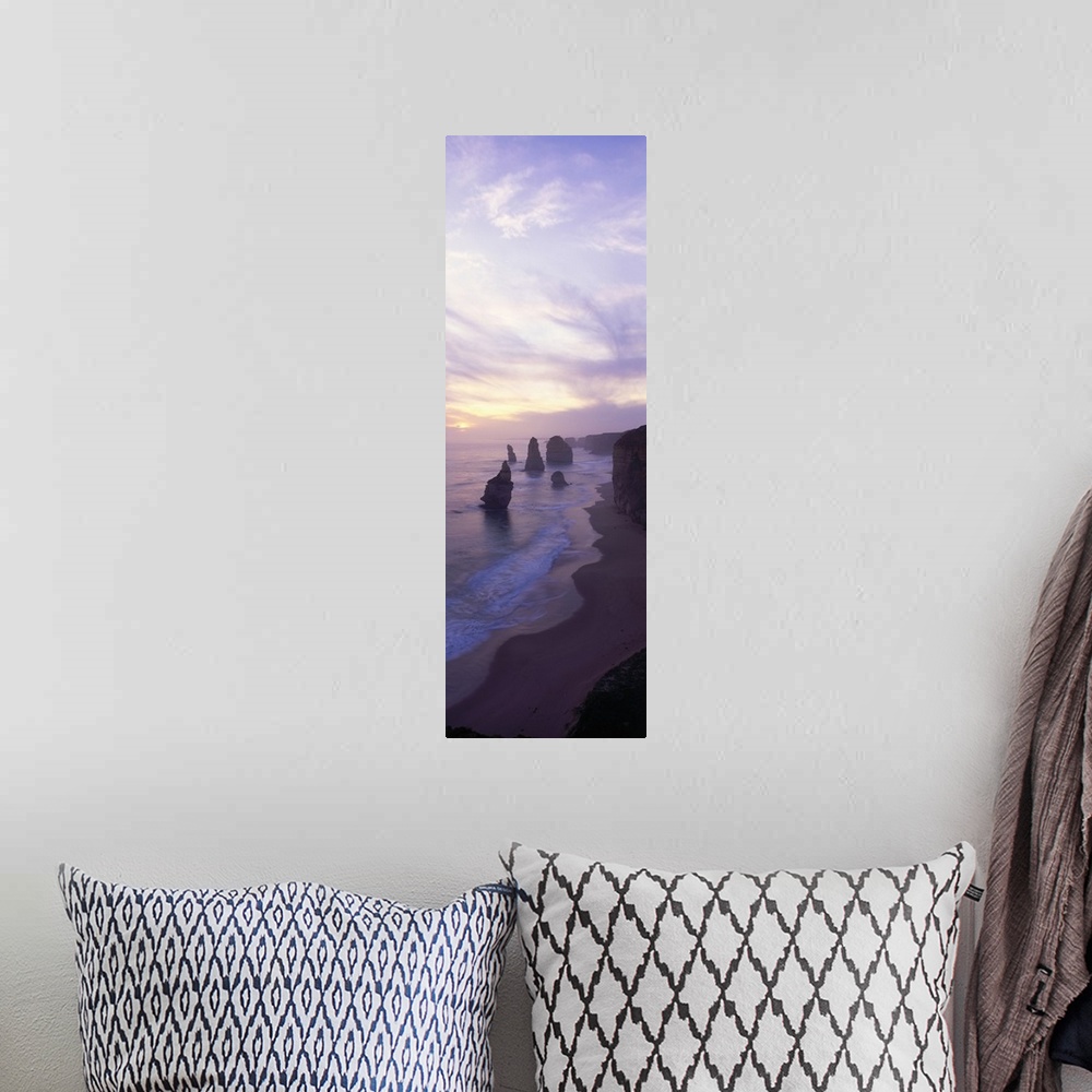 A bohemian room featuring Vertical panoramic photograph of shore with tall vertical rock formations in the ocean under clou...