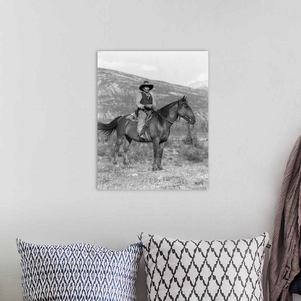 A bohemian room featuring 1920s Native American Man On Horseback Wearing Cowboy Clothes Stoney Sioux Alberta Canada.