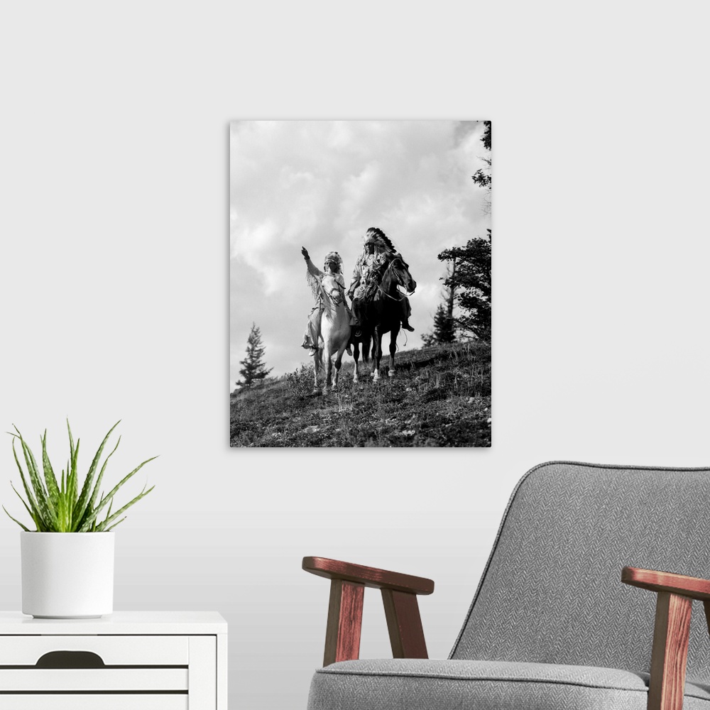 A modern room featuring 1930s Pair Of Sioux Indians In Headdresses On Horseback Pointing Out Trail.