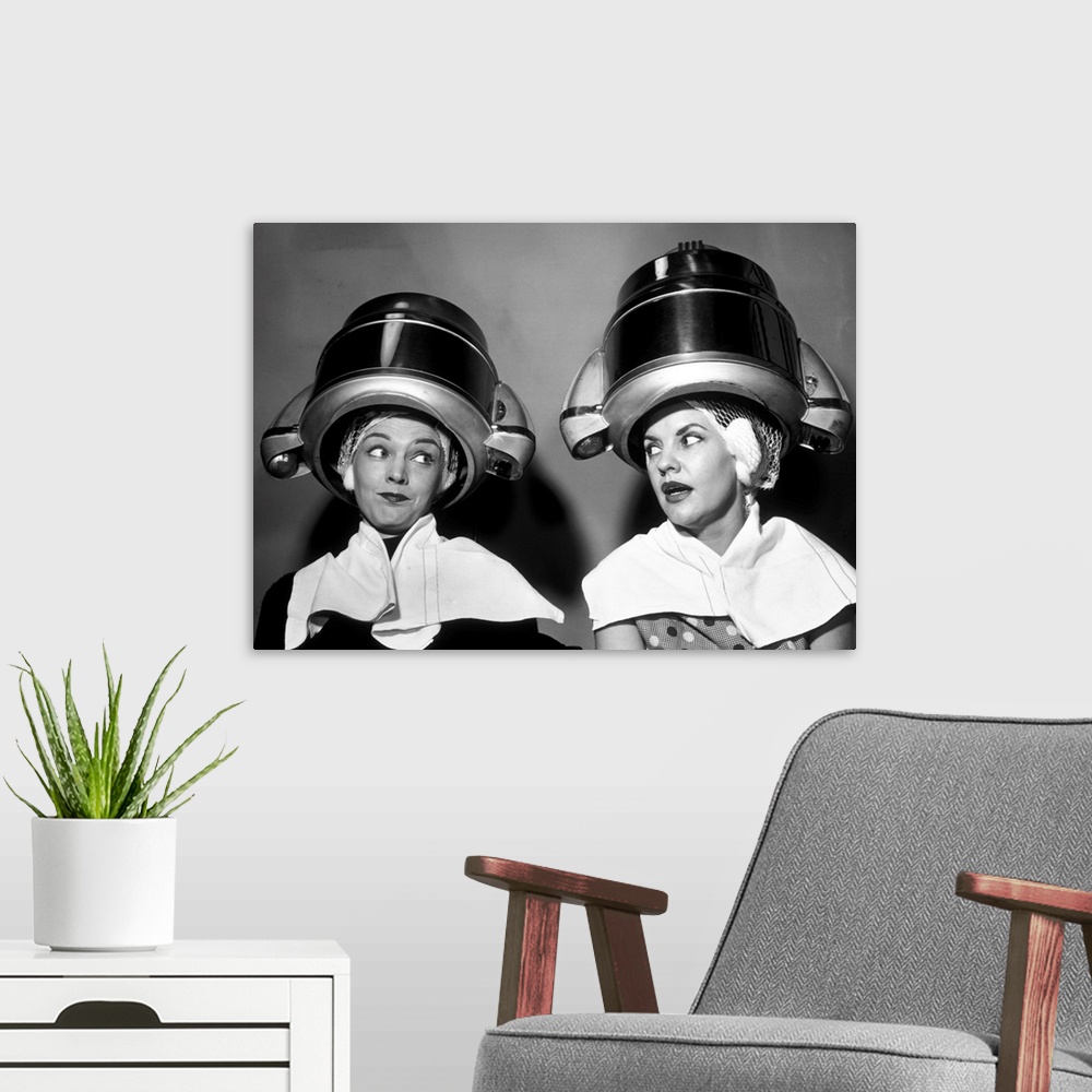 A modern room featuring 1950s Two Women Sitting Together Gossiping Under Hairdresser Hair Dryer.