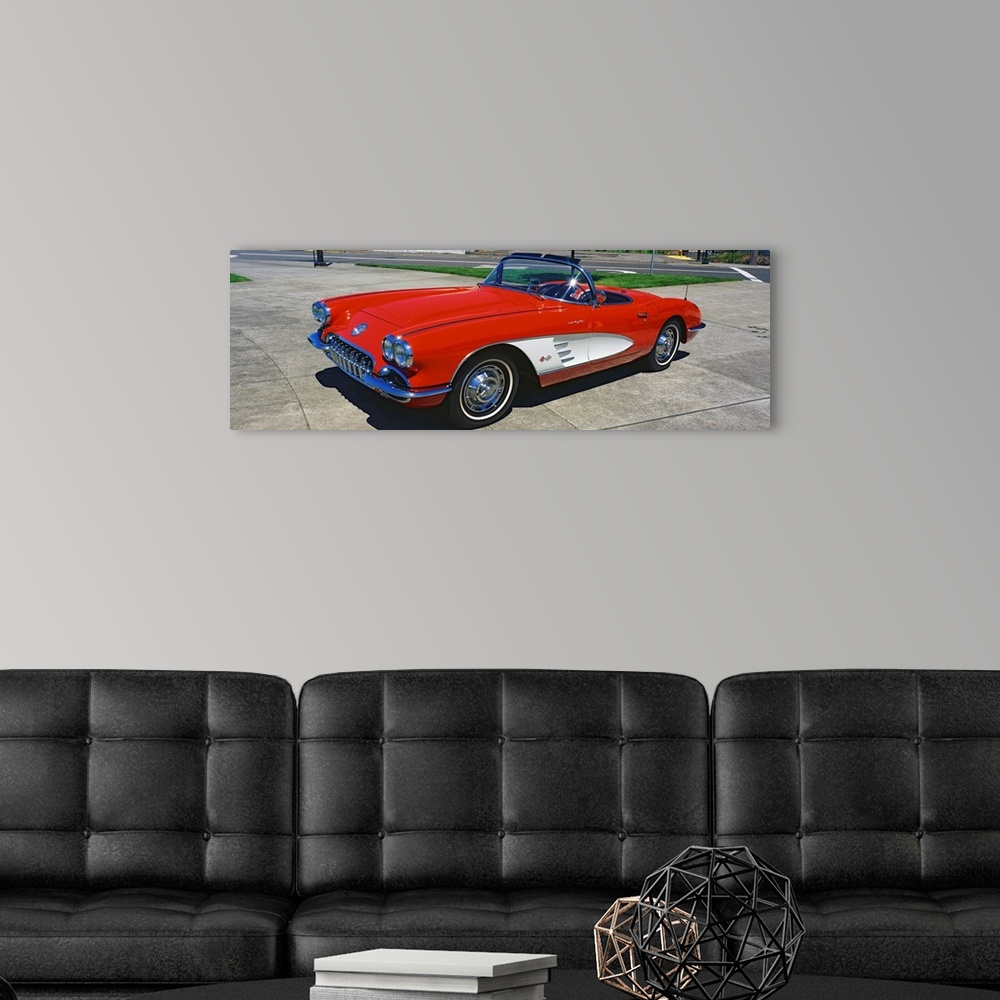 A modern room featuring This panoramic photograph shows a vintage muscle car convertible parked on pavement.