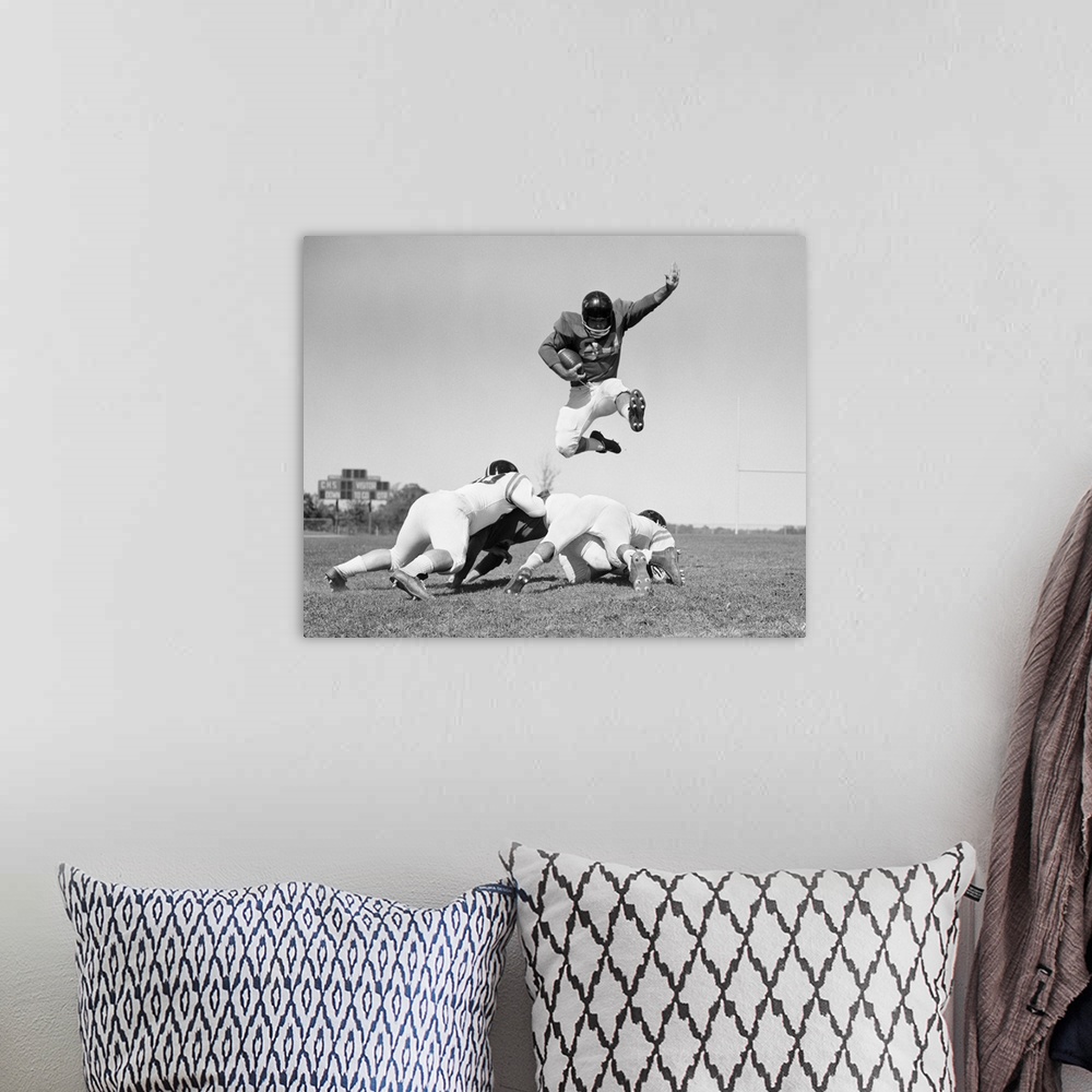 A bohemian room featuring 1960's Football Player Jumping Over Blocked Players