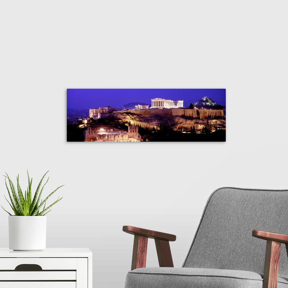 A modern room featuring Panoramic photograph of ancient citadel that contains several remains of ancient buildings with h...