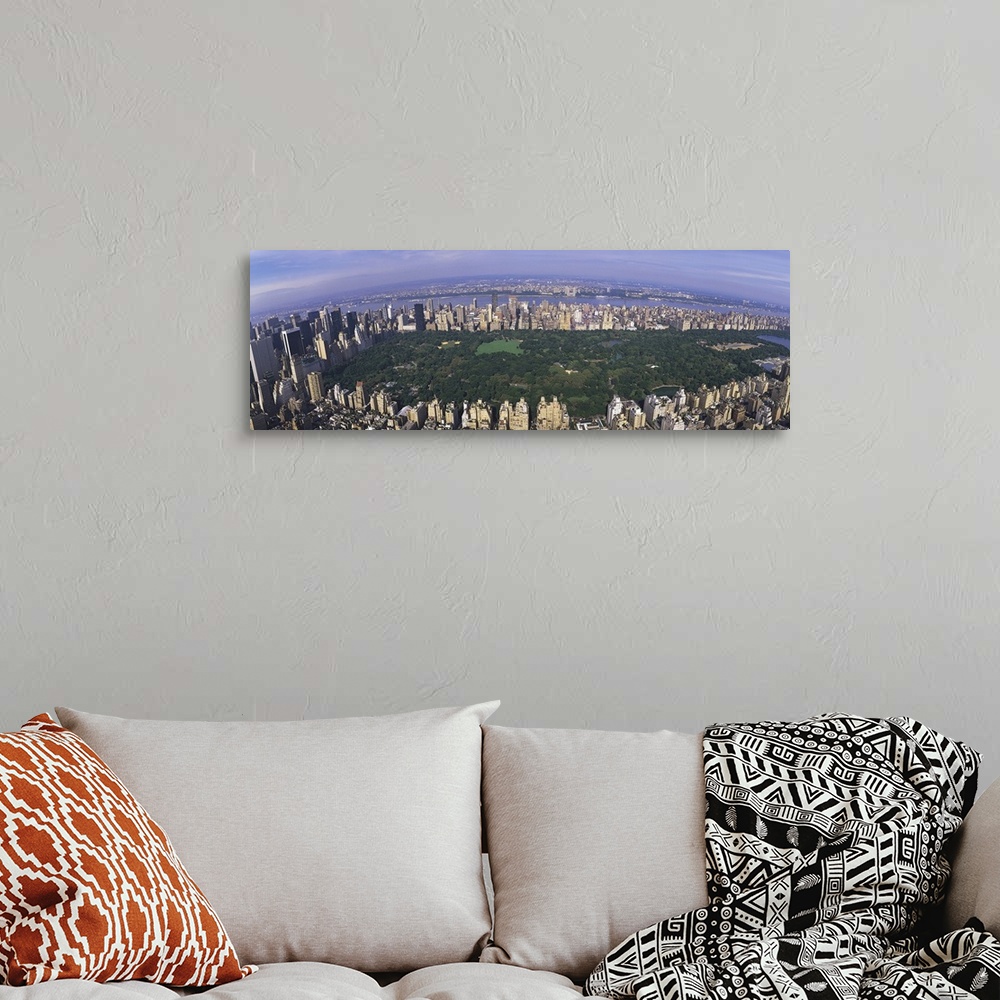 A bohemian room featuring Wide angle, aerial photograph of Central Park beneath a blue sky, surrounded by the skyscrapers o...