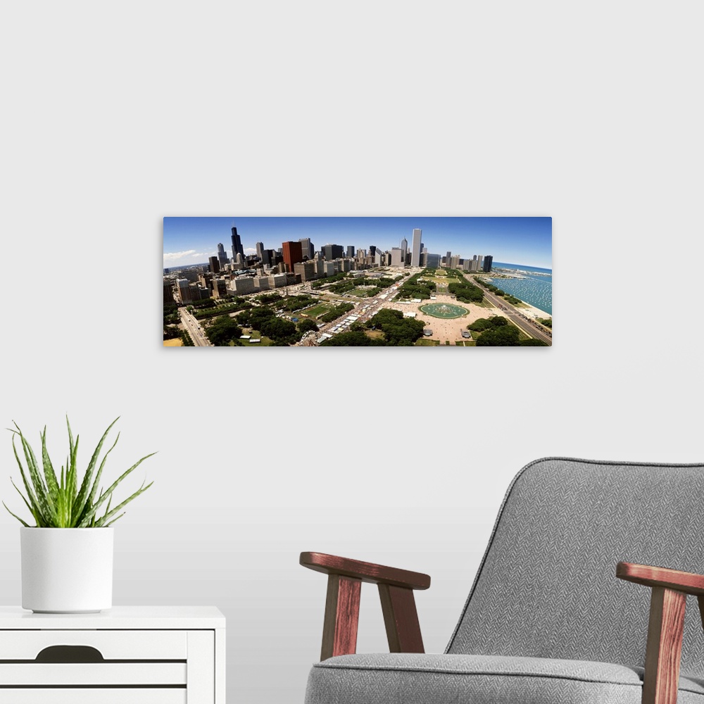 A modern room featuring The Chicago skyline and Grant Park are photographed from an aerial view with a wide angle lens.