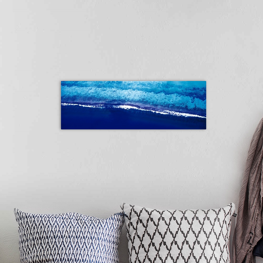 A bohemian room featuring This is a panoramic photograph taken from above of waves breaking on the shore of this tropical r...