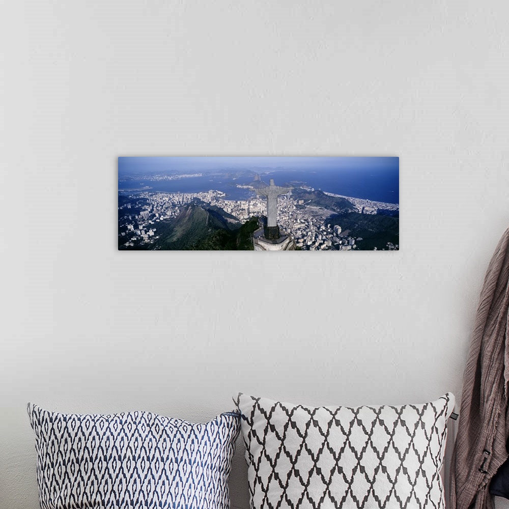 A bohemian room featuring Giant, landscape photograph of the back of Christ the Redeemer statue overlooking Rio de Janeiro,...