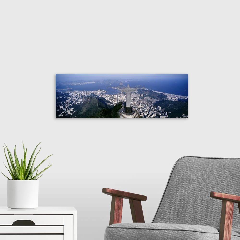 A modern room featuring Giant, landscape photograph of the back of Christ the Redeemer statue overlooking Rio de Janeiro,...