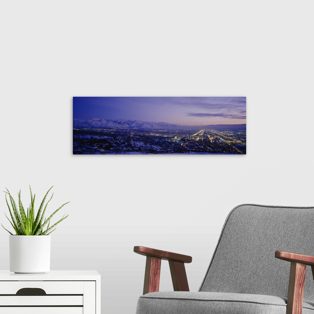 A modern room featuring Aerial panorama of Salt Lake City lights at dusk.