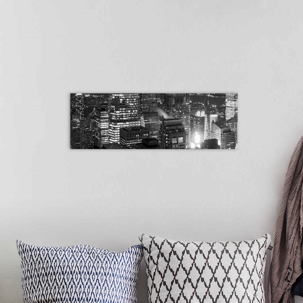 A bohemian room featuring Panoramic photograph of lit up buildings in the "Big Apple."