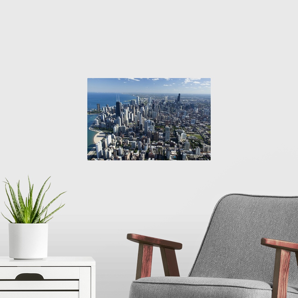 A modern room featuring Oversized, landscape, aerial photograph of Chicago, Illinois, along the Lake Michigan shoreline.