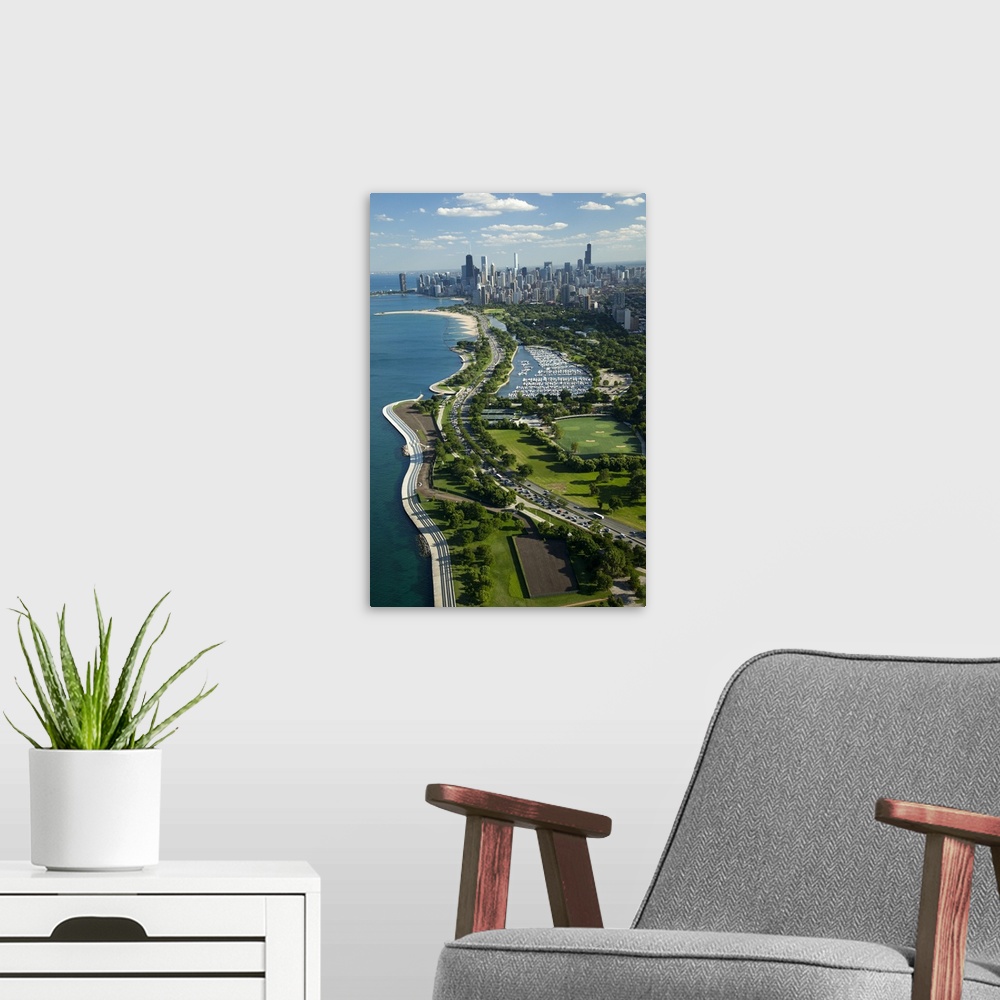 A modern room featuring Giant, vertical, aerial photograph of the Lake Michigan shoreline, along Lake Shore Drive in Chic...