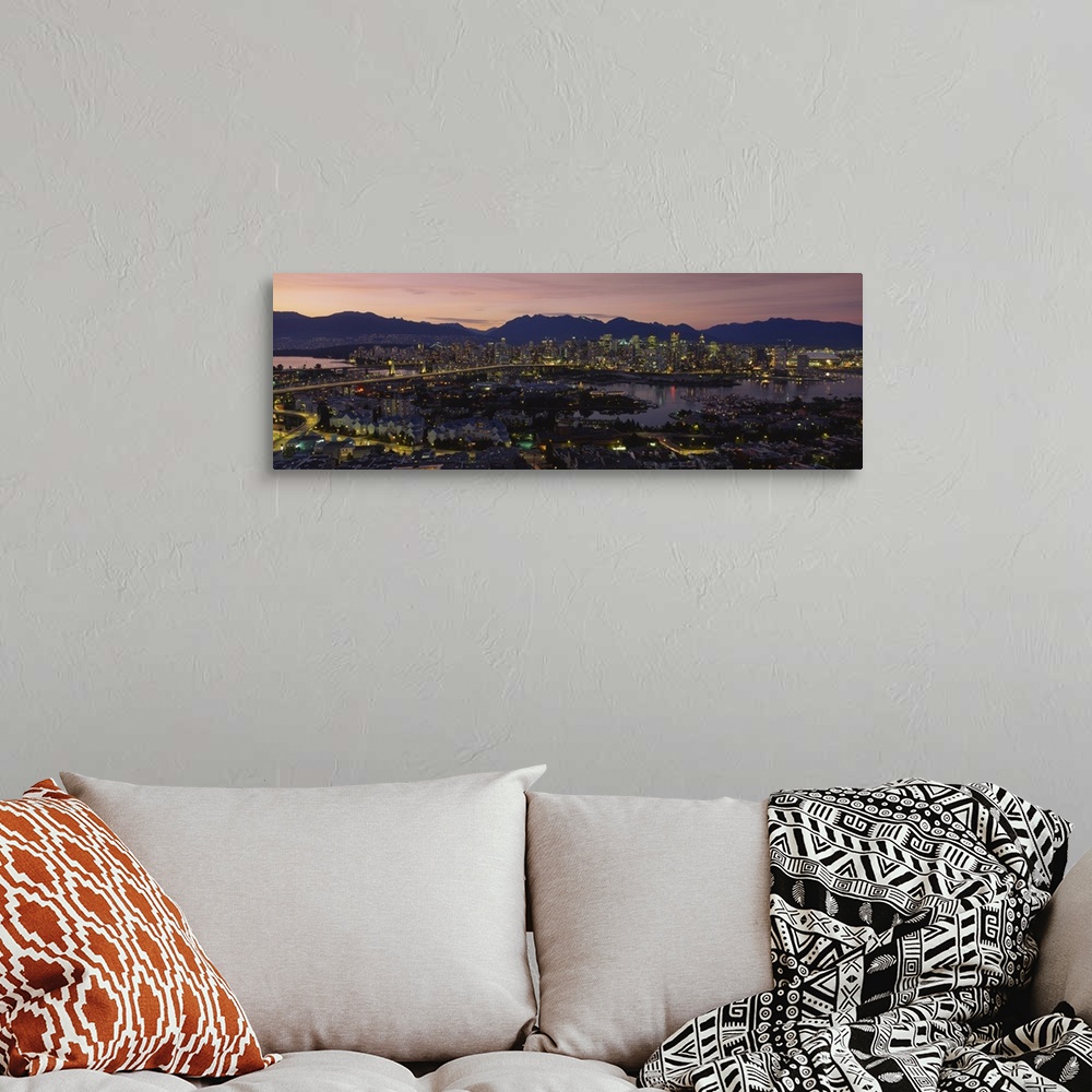 A bohemian room featuring Panoramic photograph of skyline and waterfront at sunset with buildings lit up and mountain silho...