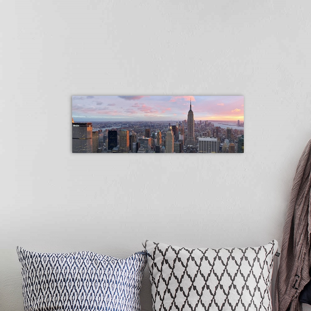A bohemian room featuring Panoramic canvas of the NYC cityscape seen from above with a beautiful sunset and views of the wa...