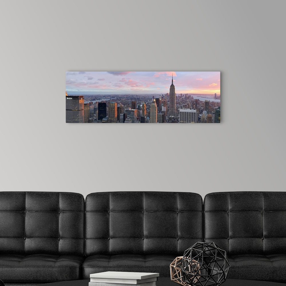 A modern room featuring Panoramic canvas of the NYC cityscape seen from above with a beautiful sunset and views of the wa...