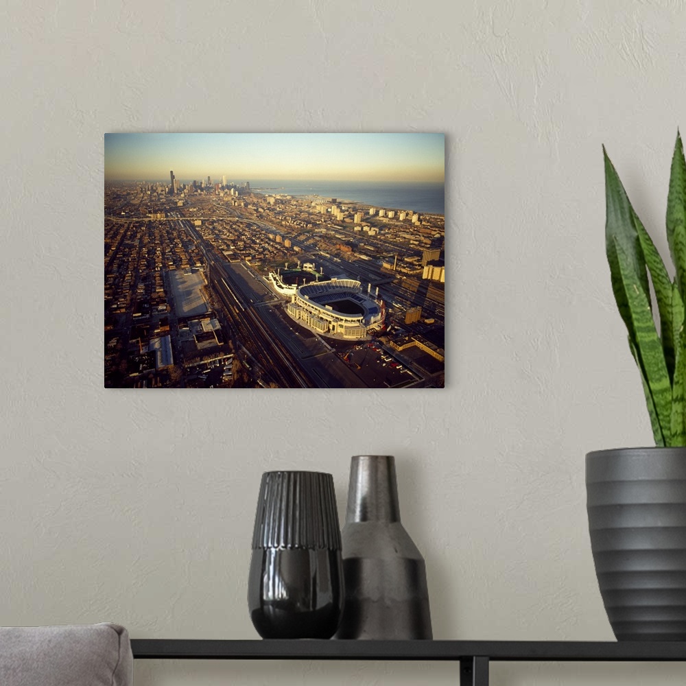A modern room featuring Big canvas photo of a stadium viewed from above with skyscrapers around it and a waterfront to th...