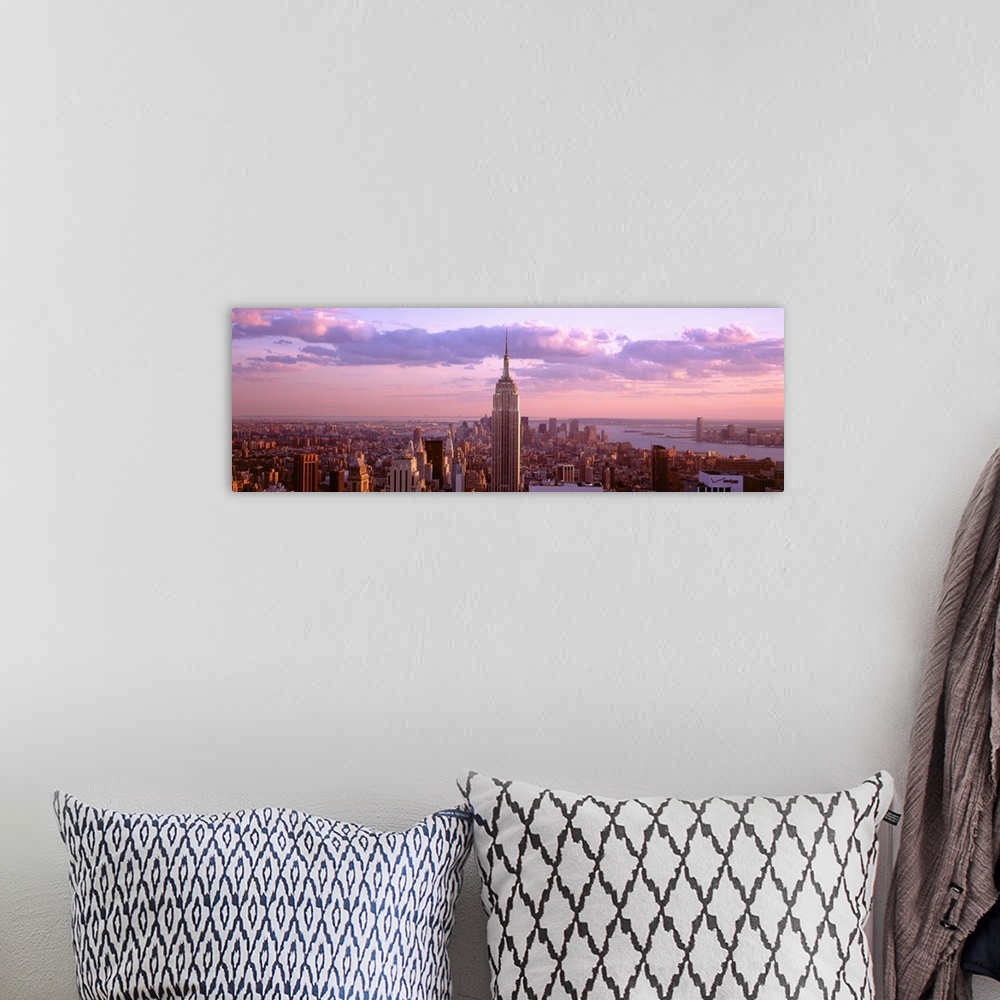 A bohemian room featuring Aerial panoramic picture of New York City and the top of the Empire State Building in the pink gl...