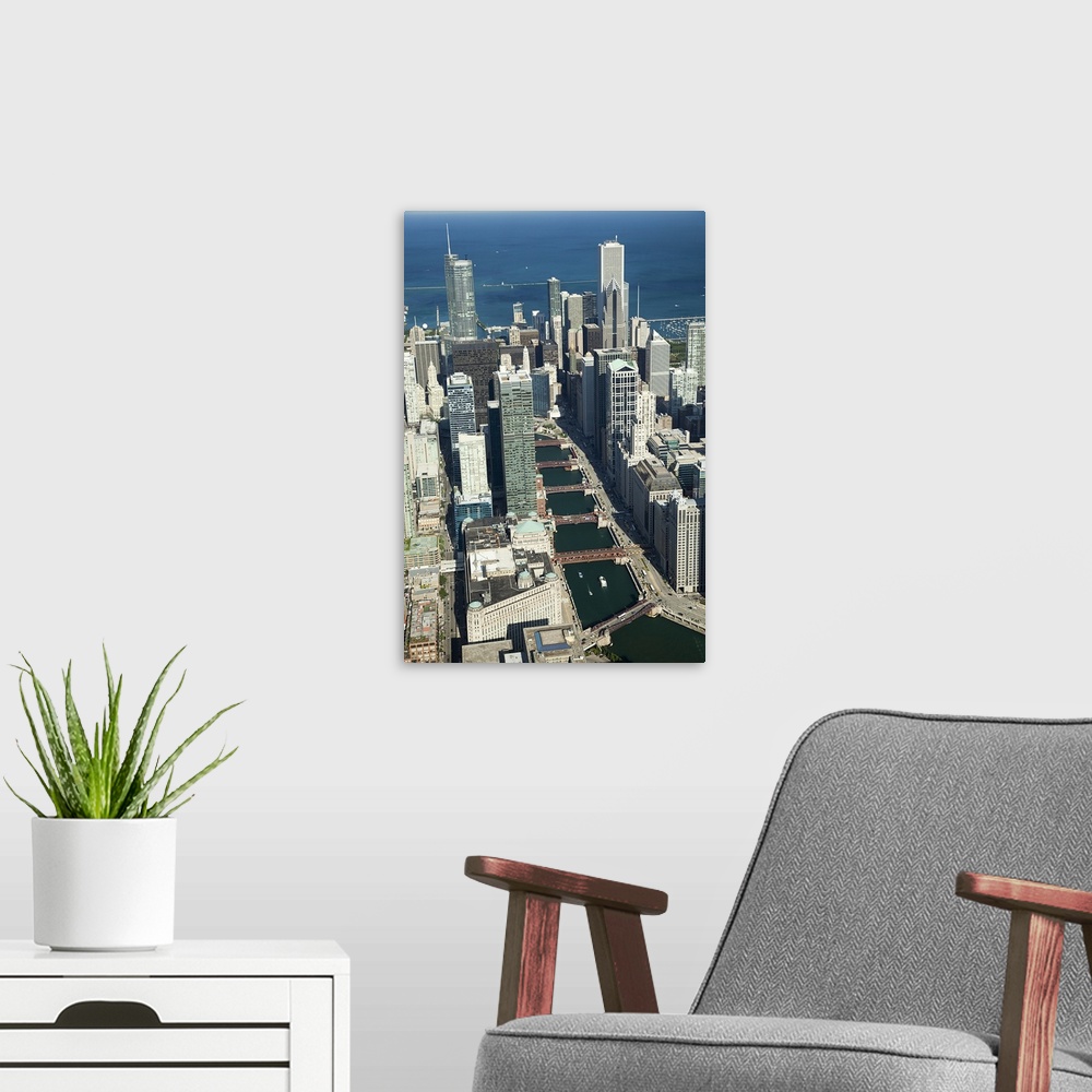A modern room featuring Tall photo print of the Chicago cityscape seen from above with the Chicago River curving through it.