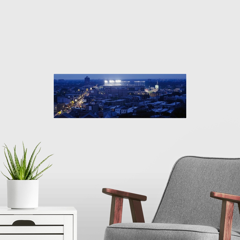 A modern room featuring This high angle photograph is taken from a distance but focused on the Chicago Cubs stadium as it...