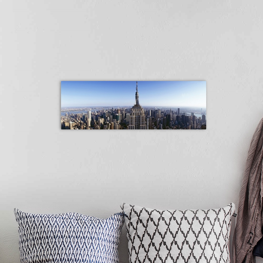 A bohemian room featuring Wide angle, aerial photograph of New York City beneath a blue sky, the Empire State Building in t...
