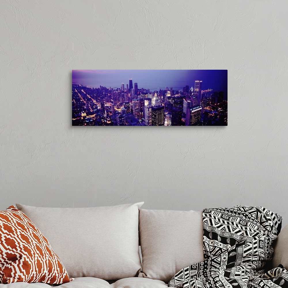 A bohemian room featuring Aerial view of buildings in a city lit up at dusk, Chicago, Illinois