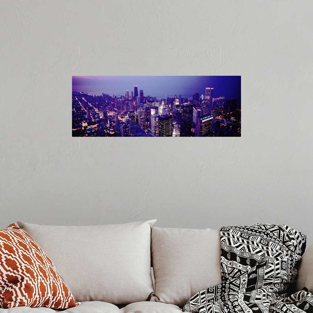 A bohemian room featuring Aerial view of buildings in a city lit up at dusk, Chicago, Illinois