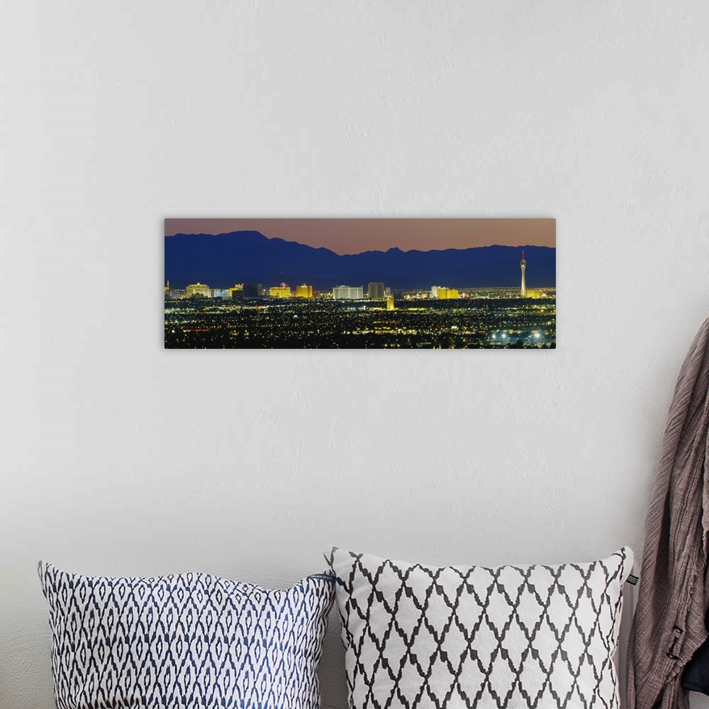 A bohemian room featuring Panorama of Las Vegas skyline with the Rocky Mountains in the background at night.