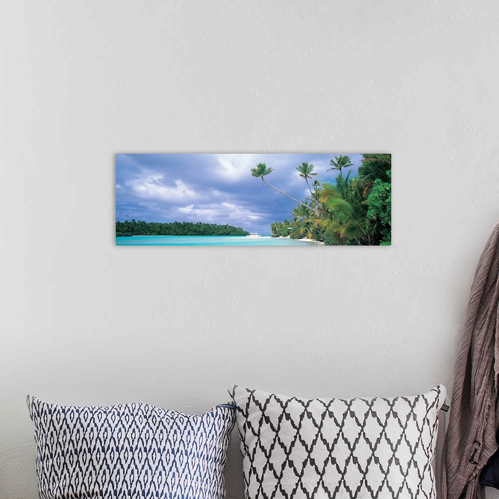 A bohemian room featuring Panoramic photograph of lagoon with shoreline full of trees and tree covered island in distance u...