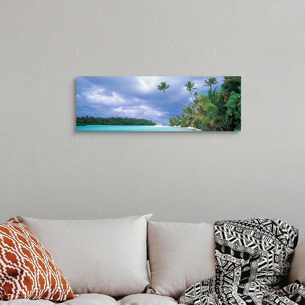 A bohemian room featuring Panoramic photograph of lagoon with shoreline full of trees and tree covered island in distance u...