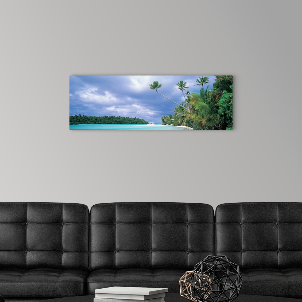 A modern room featuring Panoramic photograph of lagoon with shoreline full of trees and tree covered island in distance u...