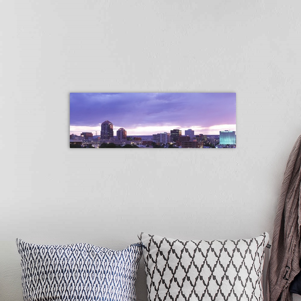 A bohemian room featuring Panoramic photograph on a big canvas of the Albuquerque skyline with lit skyscrapers at night, be...