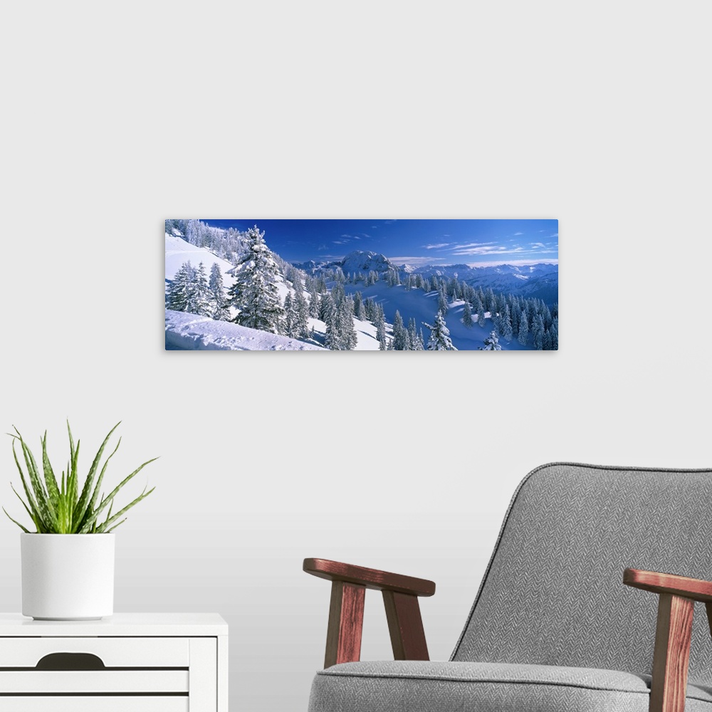 A modern room featuring This photograph is taken on the snow covered mountain of the downward slope that is covered with ...